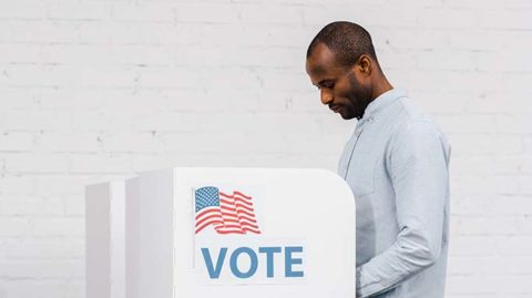 Man voting in light colored room